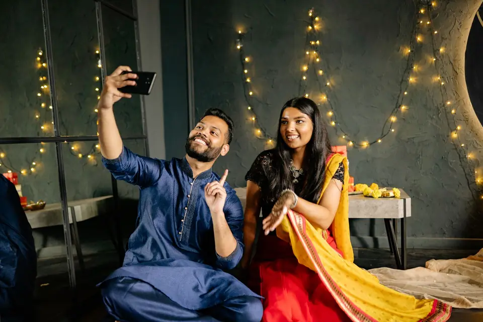 A couple in festive clothes taking a selfie together