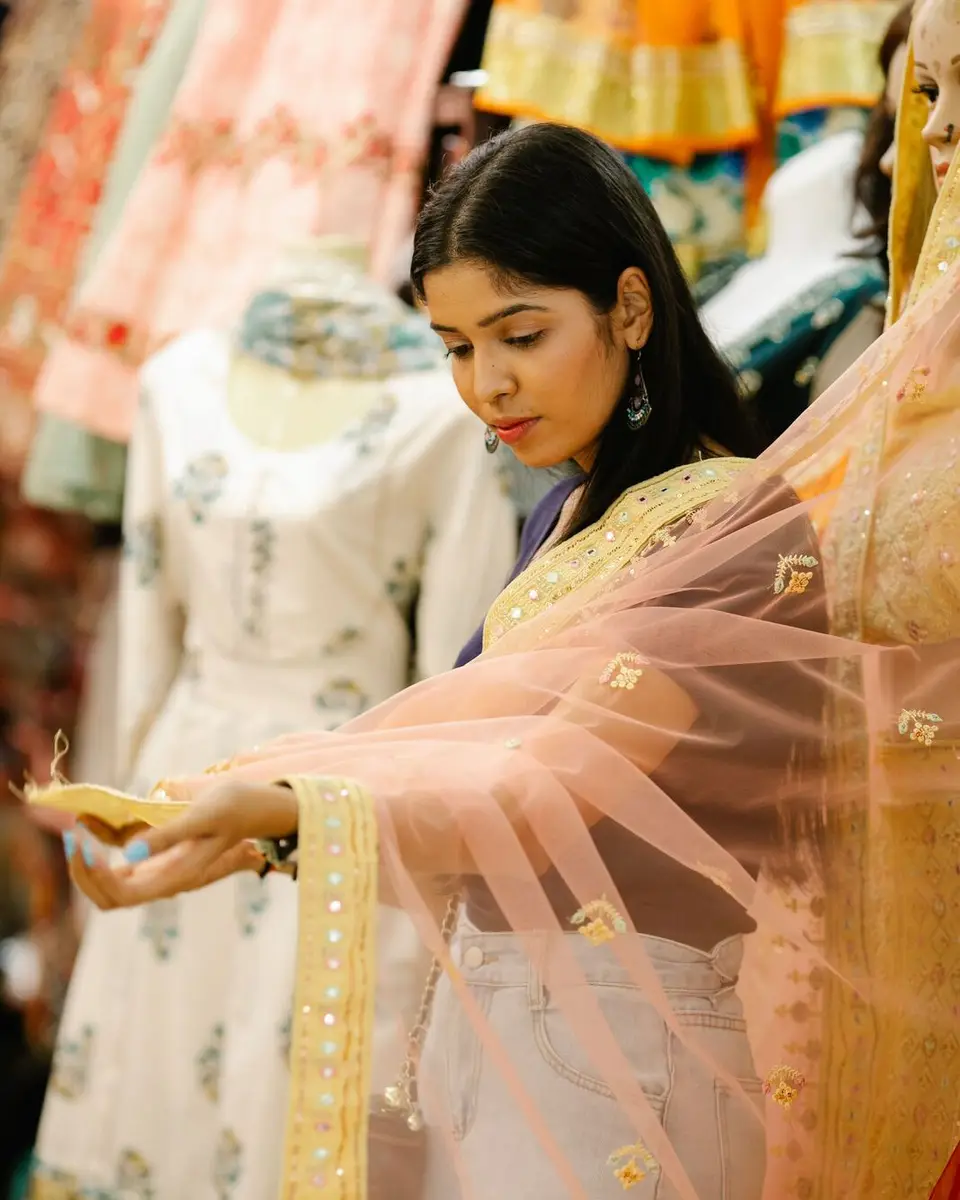 A woman looking through clothes in a boutique